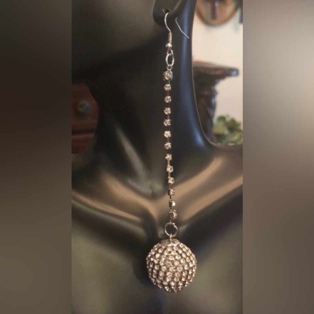 A pair of Baby Phat Spherical Dangling Silvertone Rhinestone Earrings
